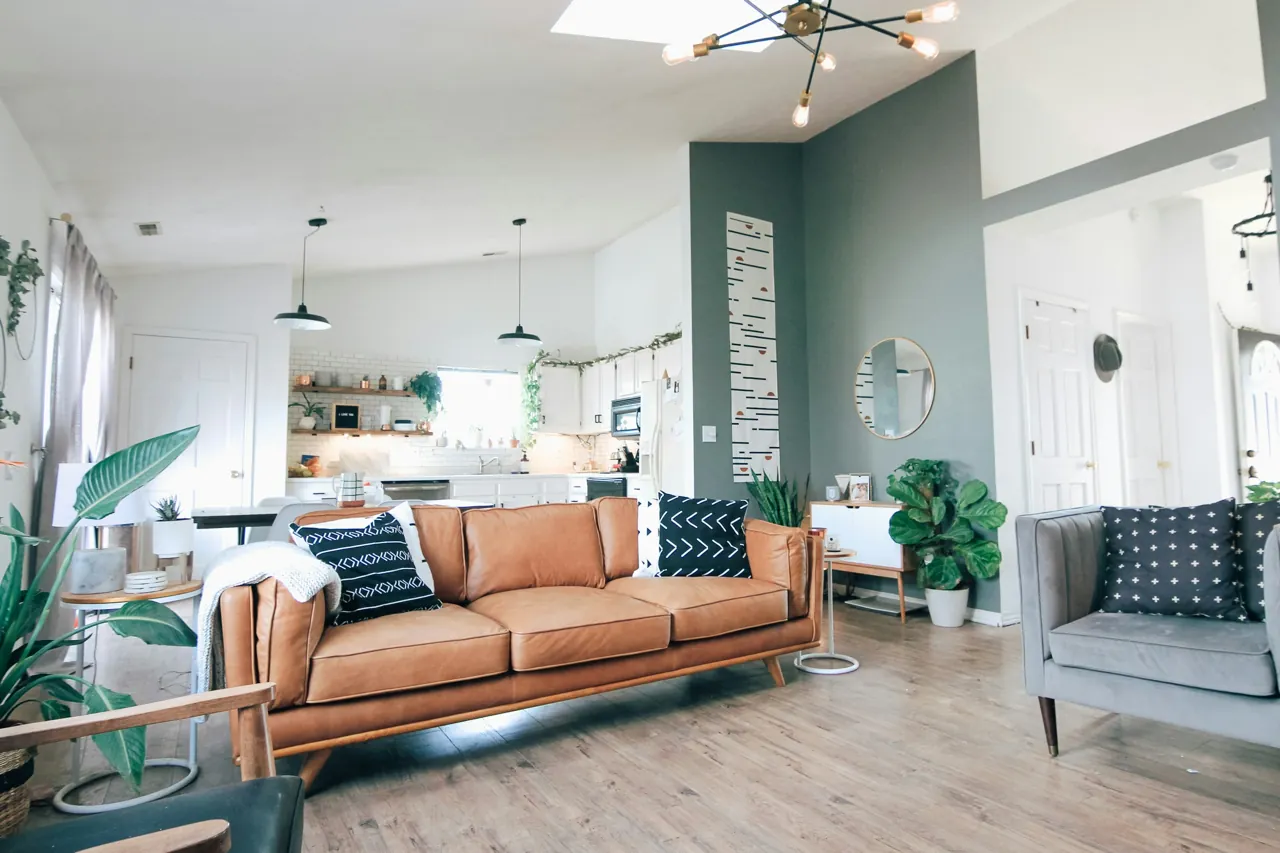 Personal living room with leather sofa and greenery — editorial photograph