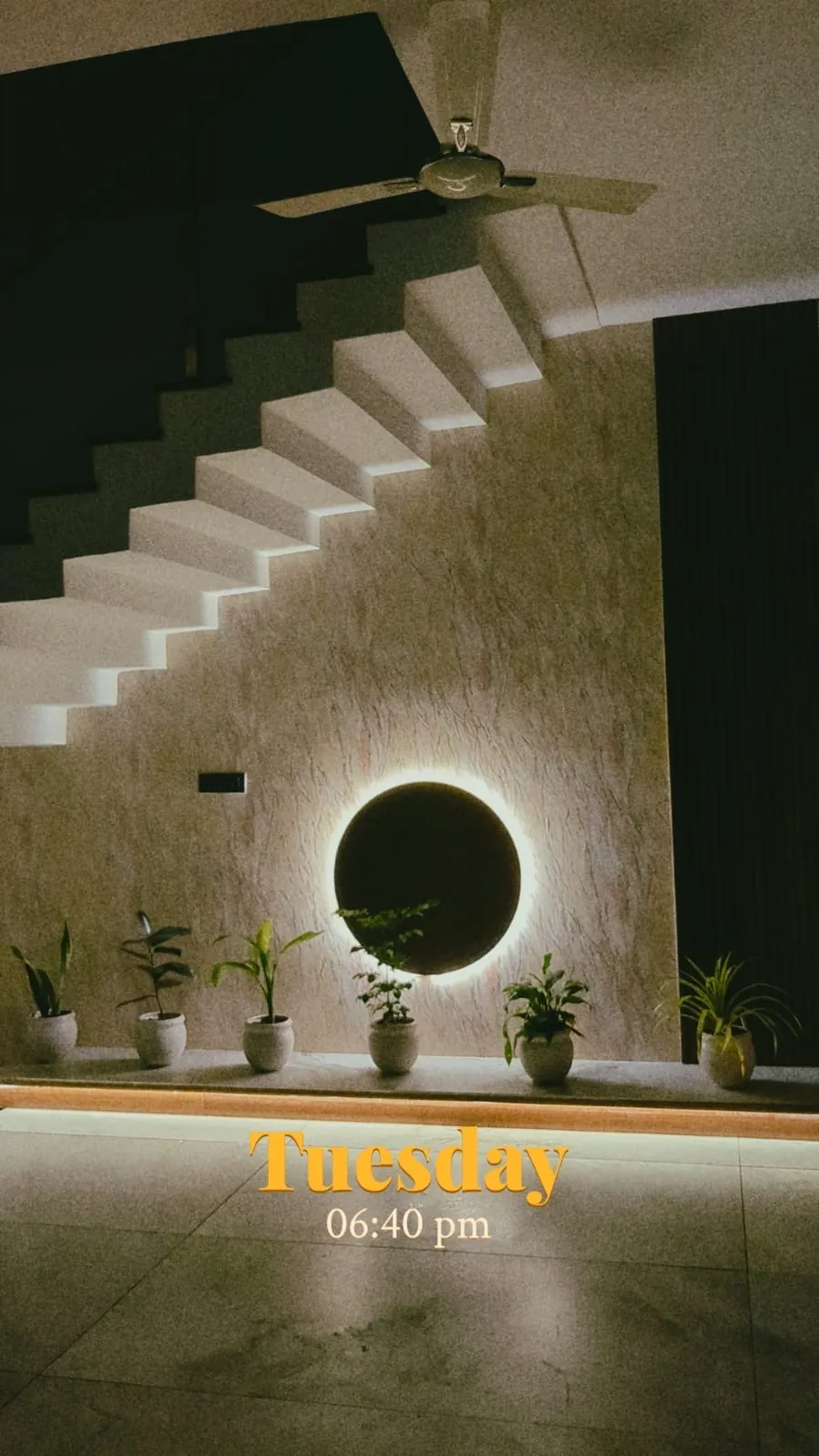 Illuminated mirror and vanity beneath a staircase