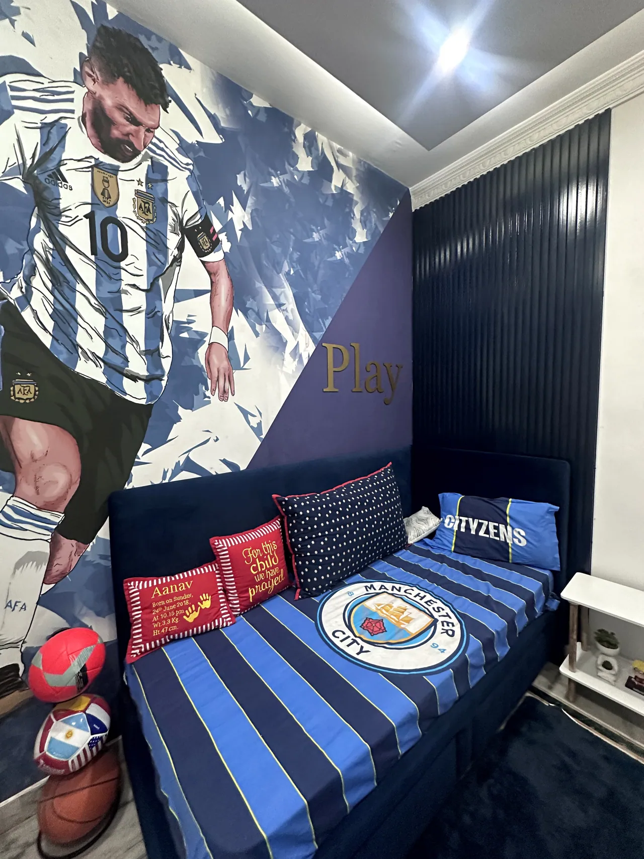 Football-themed bed and mural from the opposite side of the room