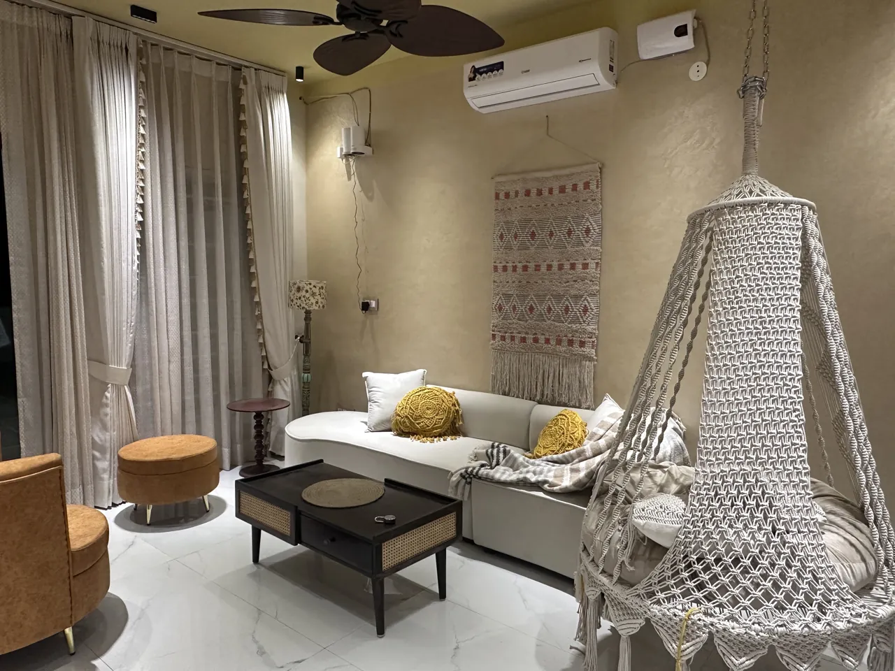 Bohemian living room at Opera Home with woven swing and soft neutral seating