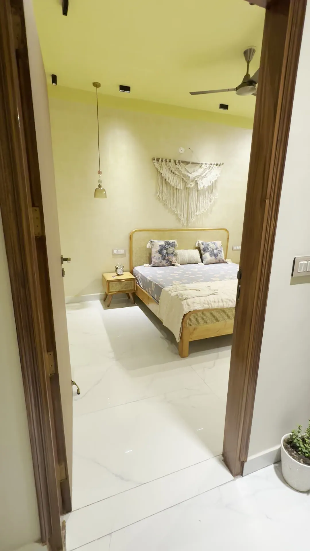 View through a timber-framed doorway towards the bedroom
