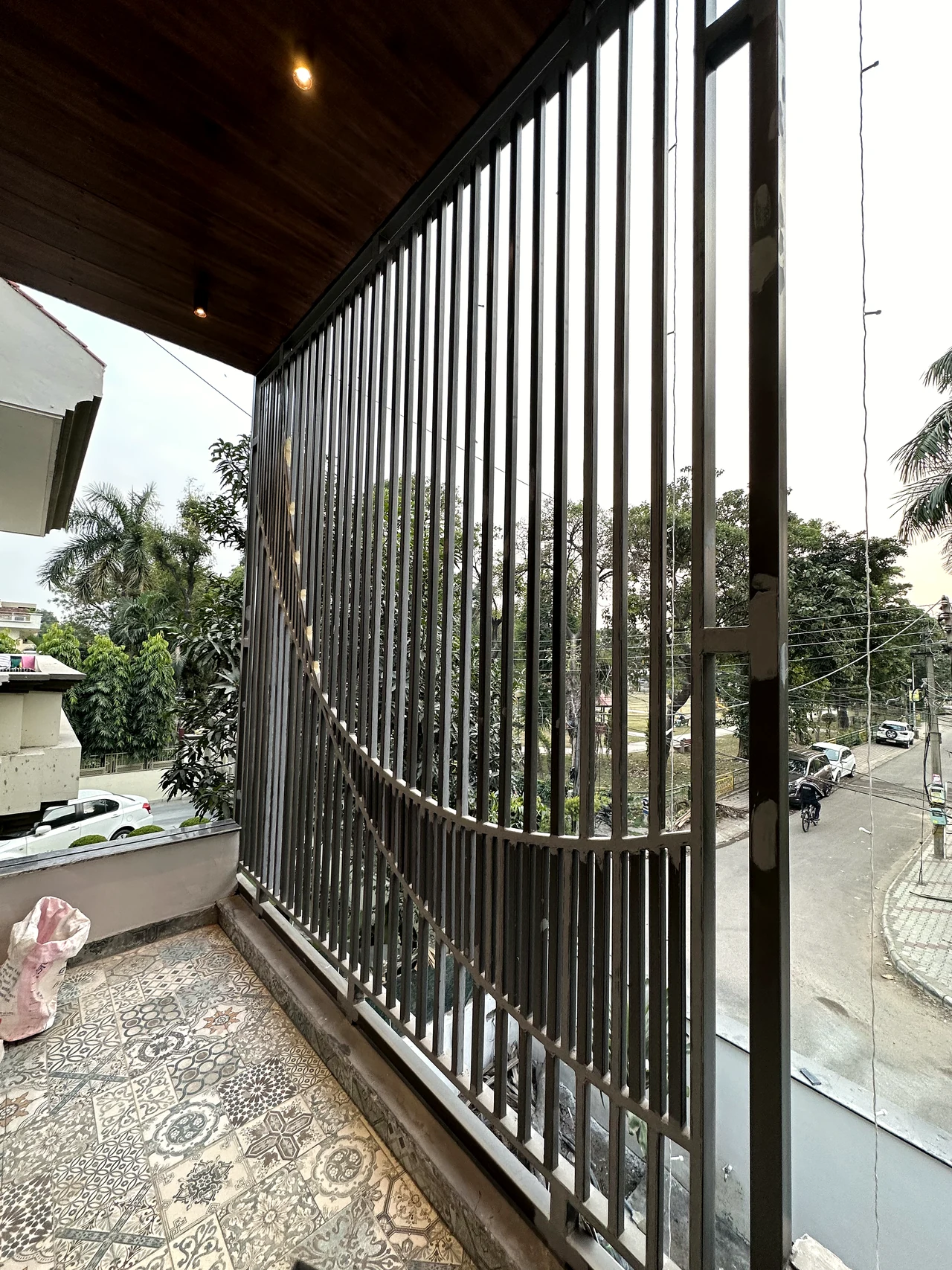 Vertical metal screen detail at the balcony edge