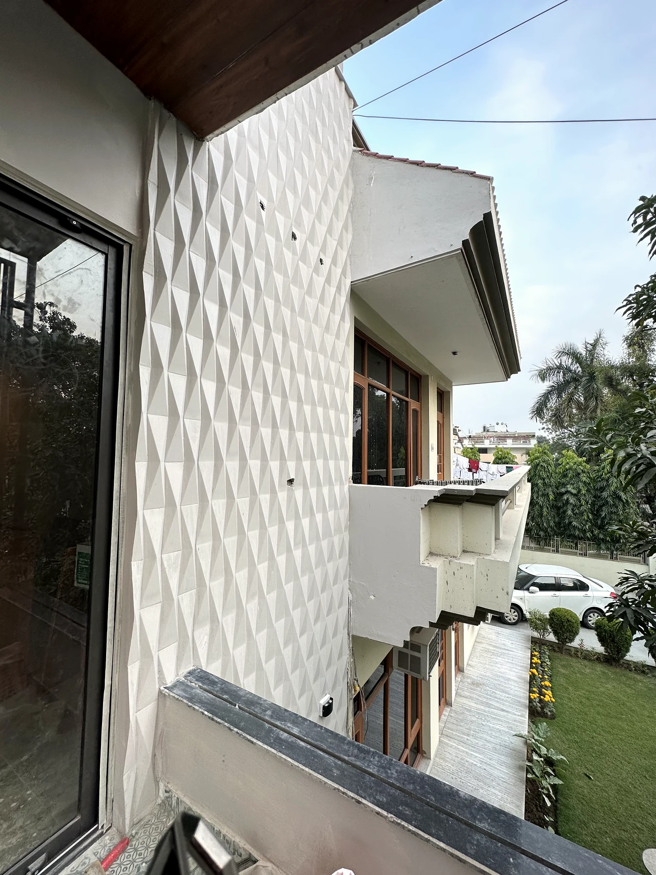 Exterior corner with sculpted white facade and timber-look soffit