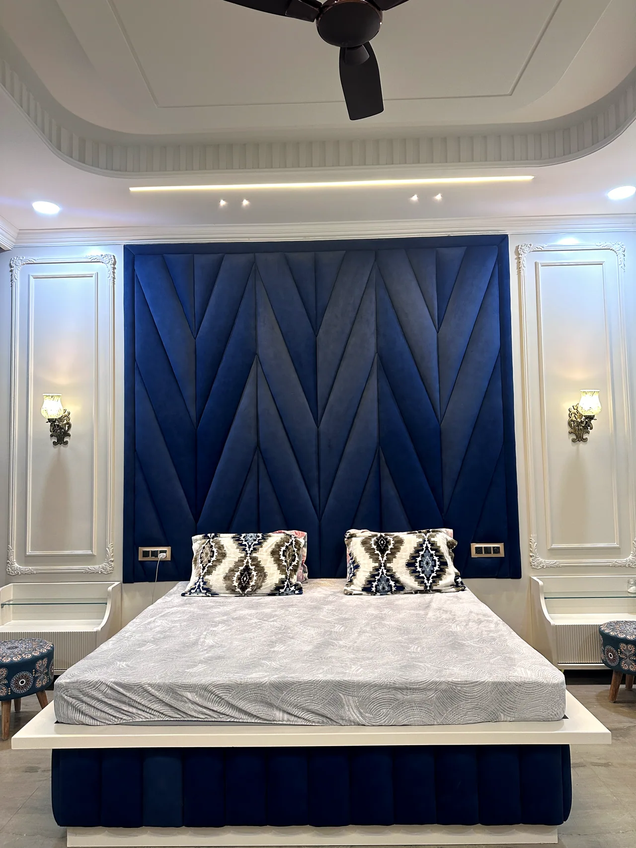 Blue bedroom viewed from the foot of the bed