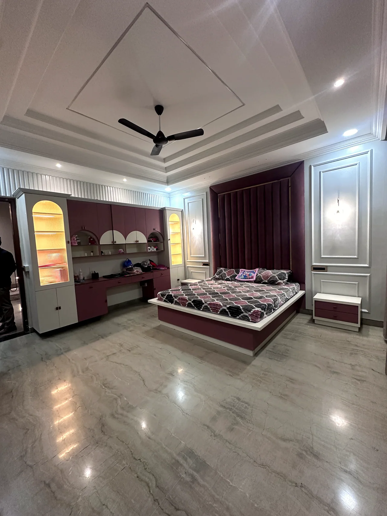 Wide bedroom view showing the bed and surrounding layout