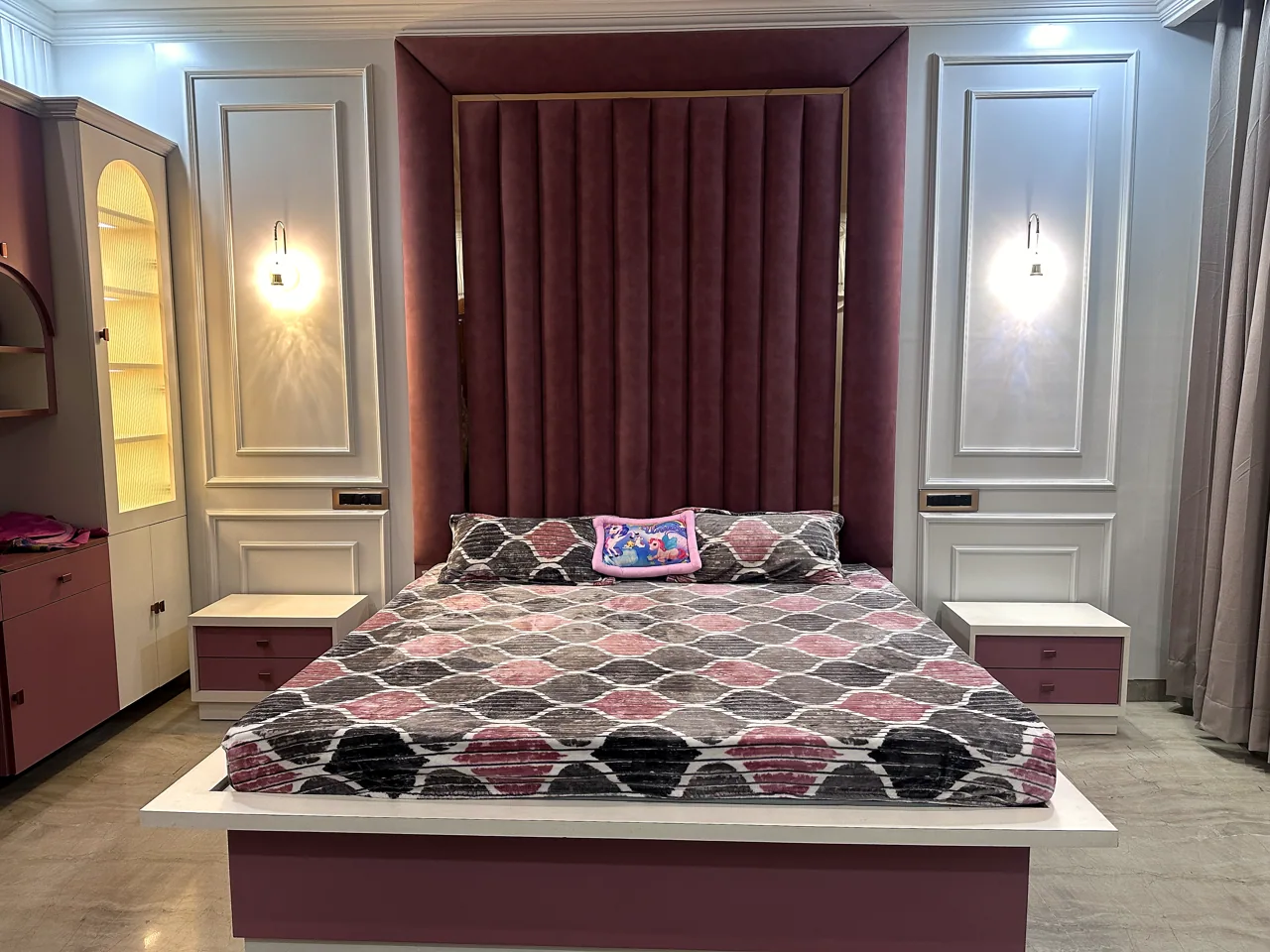 Rose-toned bedroom with upholstered feature wall