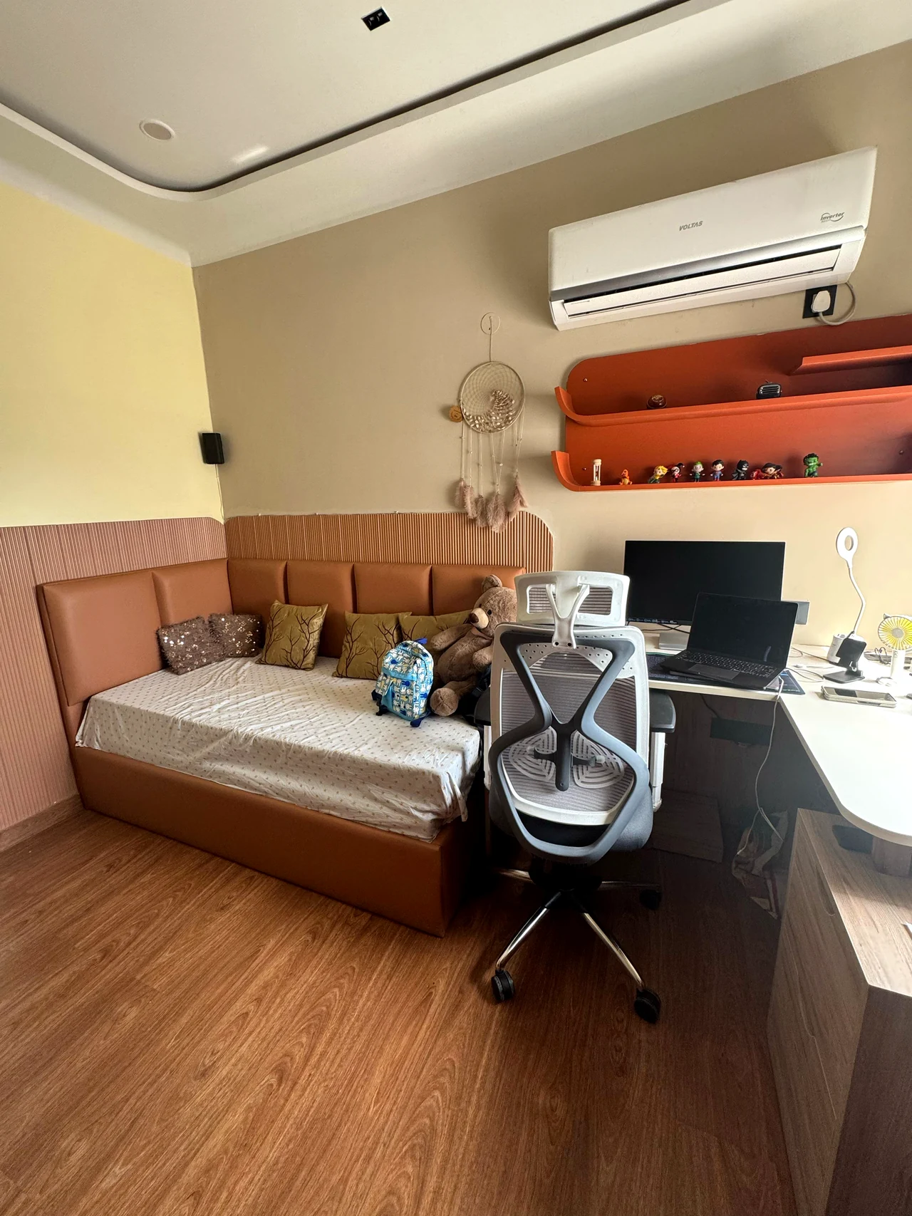 Bedroom study corner with desk, shelving and a warm wood floor