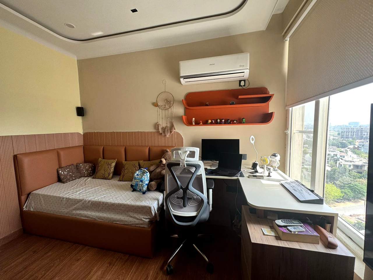 Bedroom desk and storage wall beside the window