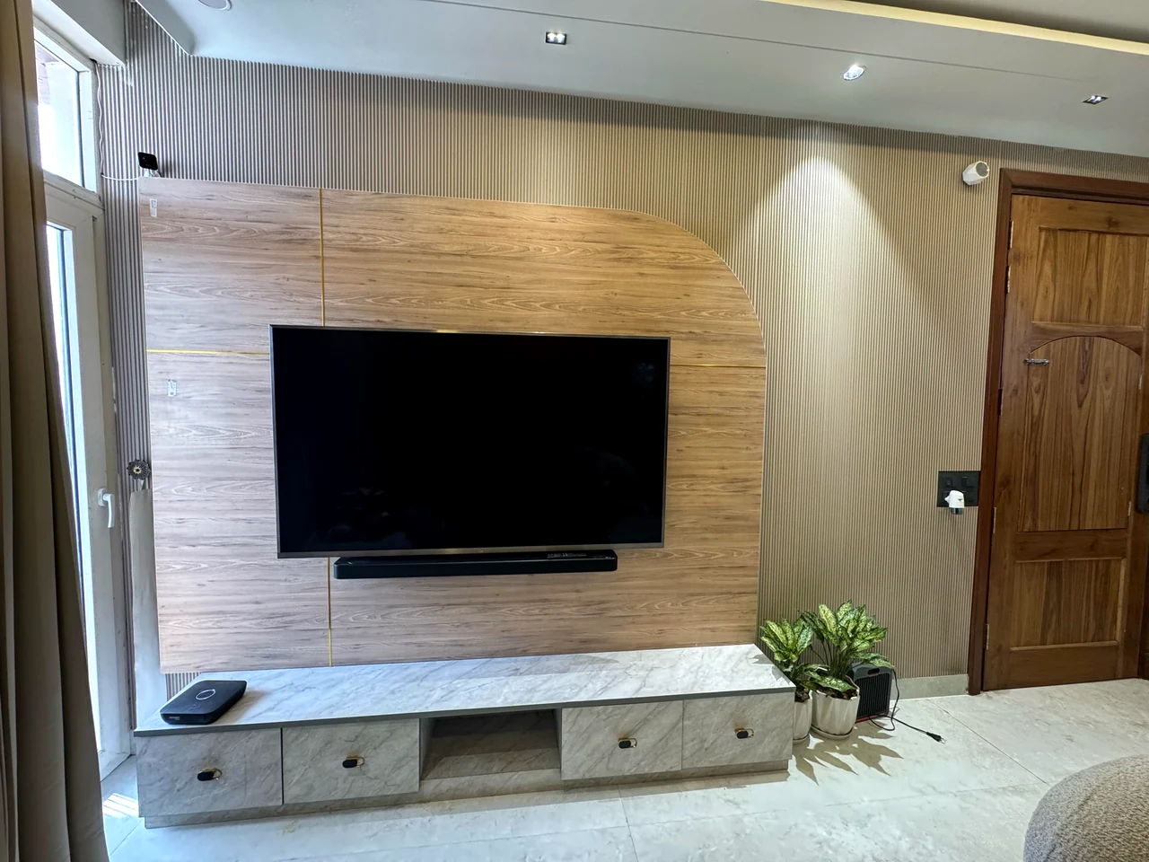 Close view of the living-room media wall, floating console and display shelf
