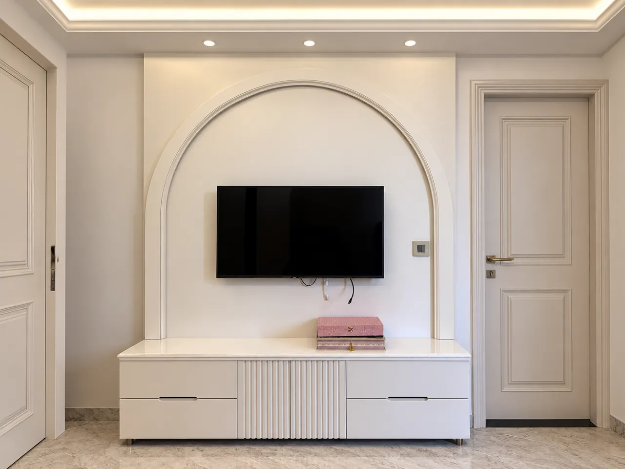 Curved TV feature wall, integrated console and ceiling lighting at Yogesh Residence, Zirakpur